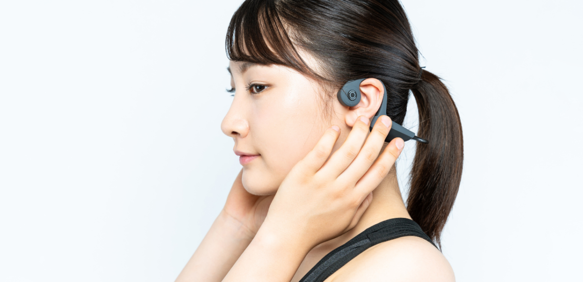 Woman wearing bone conducting headphones