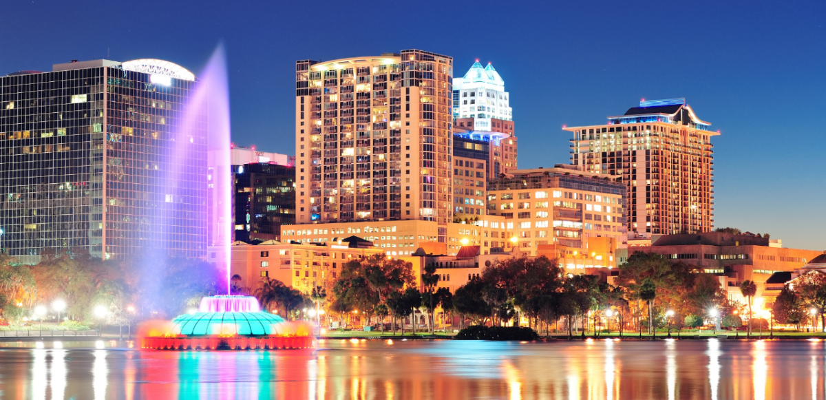 illustrative photo of lake eola park at night, showcasing Orlando's landmark fountain