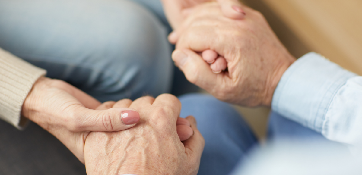 Two pairs of hands being held