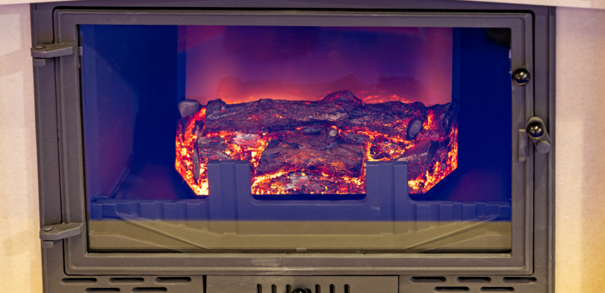 An infrared heater designed to resemble a fireplace.