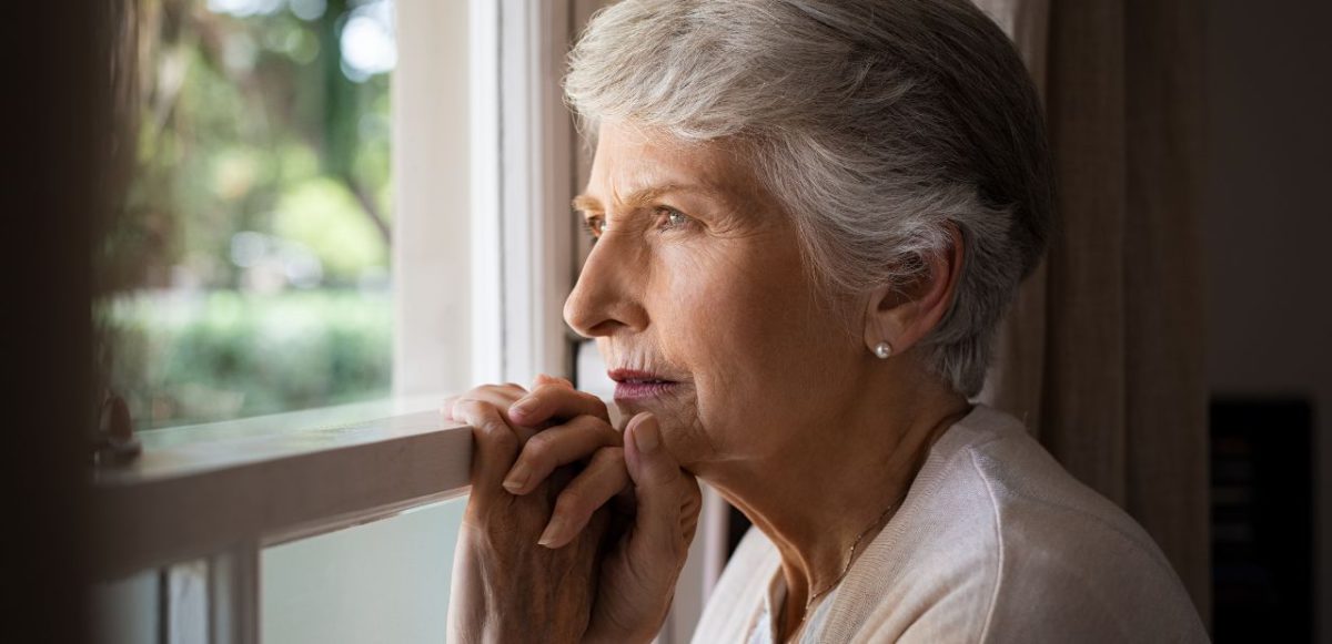 Senior woman looking out window