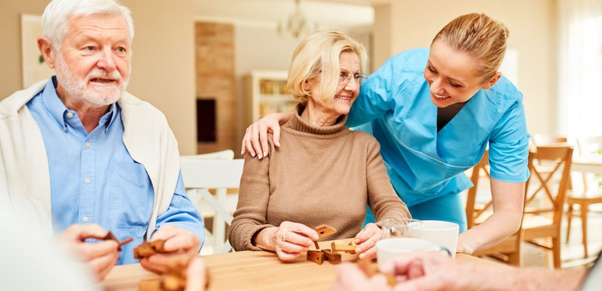 Nurse speaking to a group of seniors undergoing occupational therapy